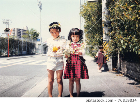 Old film photo Children with white clover crowns on their heads 76819834