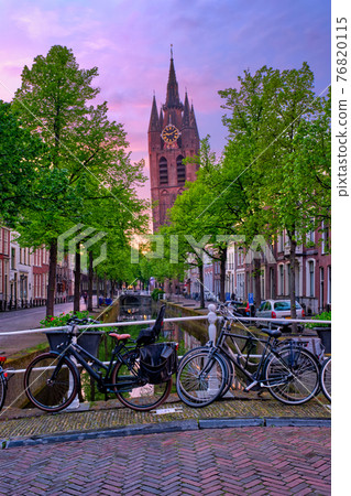 Delt street with bicycles on bridge over canal 76820115