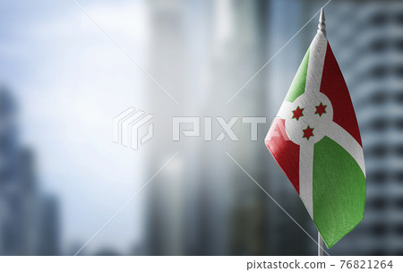 A small flag of Burundi on the background of a blurred background 76821264