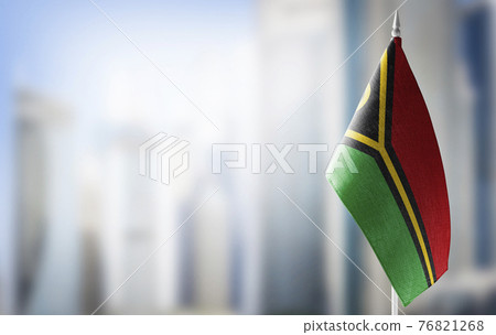 A small flag of Vanuatu on the background of a blurred background A small flag of Vanuatu on the background of a blurred background 76821268