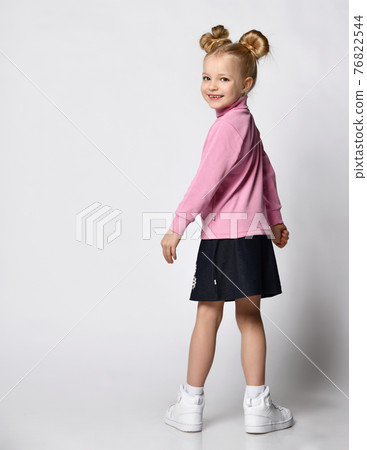 blonde with a stylish hairstyle in a pink blonde with a stylish hairstyle in a pink 76822544