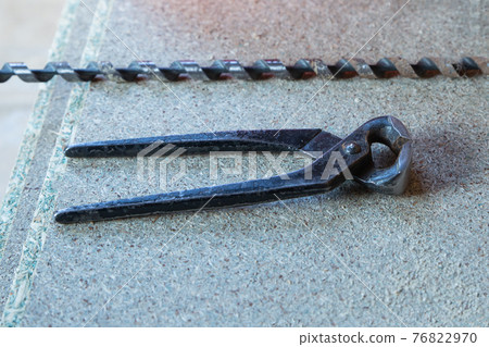 long drill and pliers master tool on wooden background 76822970