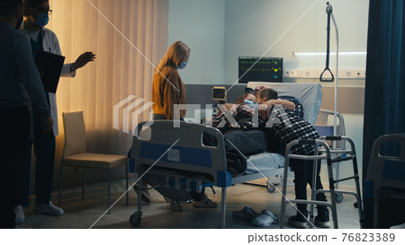 Doctor letting family to visit senior patient 76823389