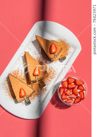 Chocolate truffle cakes with strawberries on pink abstract backgrount. Chocolate truffle cakes with strawberries on pink abstract backgrount. 76823971