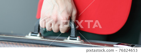 Woman in red jacket holding suitcase close-up Woman in red jacket holding suitcase close-up 76824653