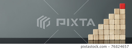 Red wooden cube is on top of other cubes 76824657