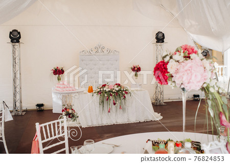 wedding table decoration with flowers on the table in the castle, table decor for dinner by candlelight.Dinner with candles 76824853