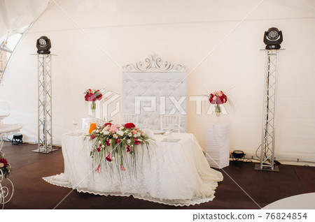 wedding table decoration with flowers on the table in the castle, table decor for dinner by candlelight.Dinner with candles 76824854
