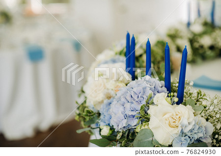 wedding table decoration with blue flowers on the table in the restaurant table decor for dinner at the wedding. 76824930