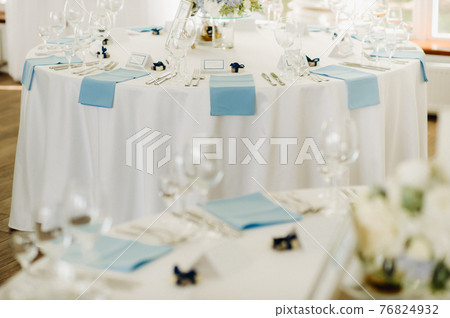 wedding table decoration with blue flowers on the table in the restaurant table decor for dinner at the wedding. 76824932