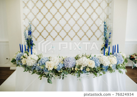 wedding table decoration with blue flowers on the table in the restaurant table decor for dinner at the wedding. 76824934