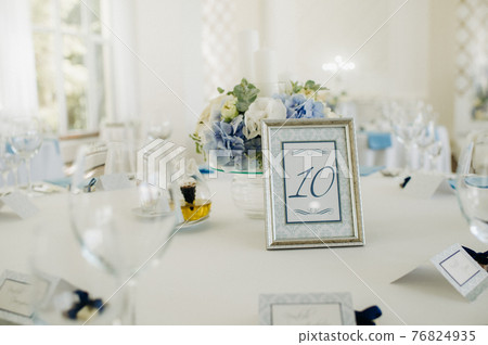wedding table decoration with blue flowers on the table in the restaurant table decor for dinner at the wedding. 76824935