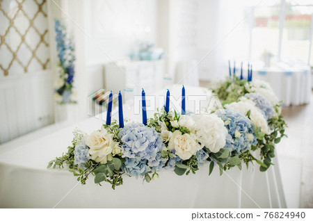 wedding table decoration with blue flowers on the table in the restaurant table decor for dinner at the wedding. 76824940