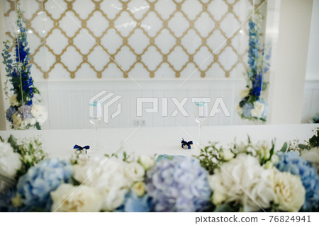 wedding table decoration with blue flowers on the table in the restaurant table decor for dinner at the wedding. 76824941