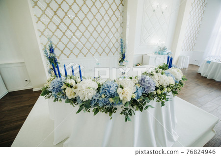wedding table decoration with blue flowers on the table in the restaurant table decor for dinner at the wedding. 76824946