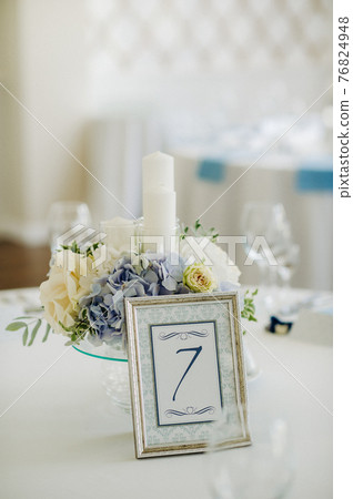 wedding table decoration with blue flowers on the table in the restaurant table decor for dinner at the wedding. 76824948