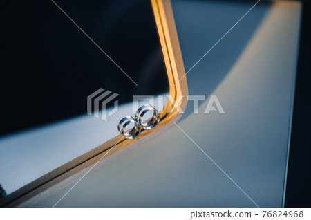 Close-up of two gold wedding rings for a wedding 76824968