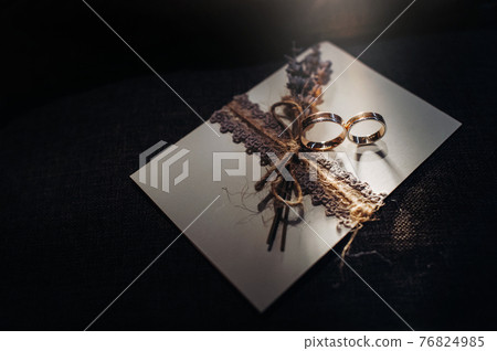 Close-up of two gold wedding rings for a wedding 76824985