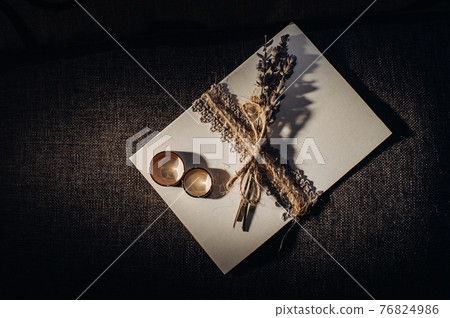 Close-up of two gold wedding rings for a wedding 76824986