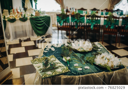 wedding table decoration with flowers on the table in green style, dinner table decor 76825029