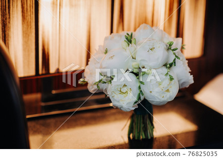 wedding bouquet with peonies at the wedding.Beautiful bouquet of flowers. 76825035