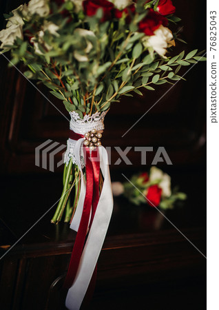 wedding bouquet with roses and boutonniere.The decor at the wedding 76825043