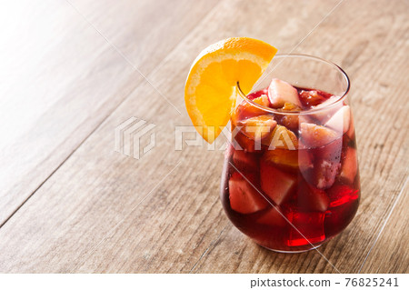 Sangria drink in glass on wooden table Sangria drink in glass on wooden table 76825241