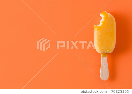 Orange popsicle on orange background 76825305