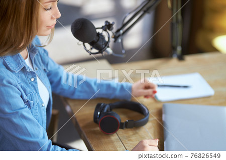 Young woman working in laptop with modern microphone. 76826549