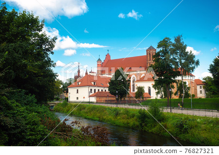 View across the river To The Roman Catholic Church Of St. Anne And The Church Of St. Francis And St. Bernard In The Old Town On A Summer Sunny Day. LITHUANIA, VILNIUS 76827321