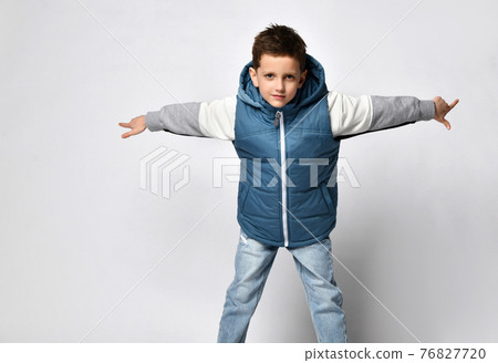 smiling teenager in a quilted or down jacket vest smiling teenager in a quilted or down jacket vest 76827720