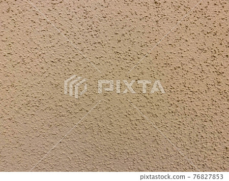 The texture of the beige yellow surface of the plaster-plastered wall with bark beetle type plaster on the wall in the entrance. The background The texture of the beige yellow surface of the plaster-plastered wall with bark beetle type plaster on the wall in the entrance. The background 76827853