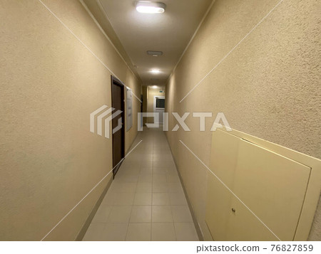 Corridor of new residential building under construction view. Aerated concrete blocks house corridor walls under construction ready for plastering, stucco. Long and narrow corridor with elevator door Corridor of new residential building under construction view. Aerated concrete blocks house corridor walls under construction ready for plastering, stucco. Long and narrow corridor with elevator door 76827859