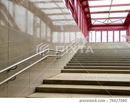 Modern descent to the pedestrian tunnel is empty without people. Stairway down to the underground new passage. Beige color Modern descent to the pedestrian tunnel is empty without people. Stairway down to the underground new passage. Beige color 76827860
