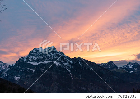 colorful sunset with mountains in swiss alps 76828333