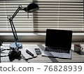 Film camera and fountain pen placed on the desk 76828939