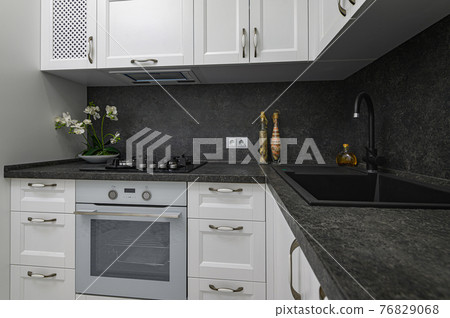 Luxury well designed modern black and white kitchen 76829068