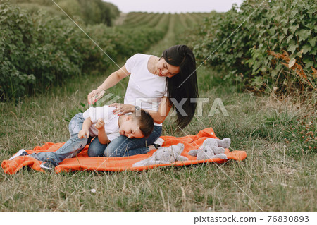 Cute and stylish family in a summer park 76830893