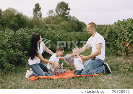 Cute family playing in a summer field Cute family playing in a summer field 76830901