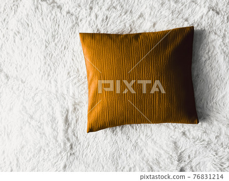Golden cushion throw pillow on white fluffy plaid blanket as flat lay background, bedroom top view and home decor Golden cushion throw pillow on white fluffy plaid blanket as flat lay background, bedroom top view and home decor 76831214