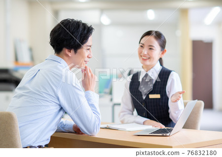 A business woman who consults with a young man A business woman who consults with a young man 76832180