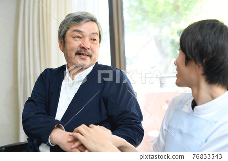 White-haired senior (middle-aged) man having a conversation 76833543