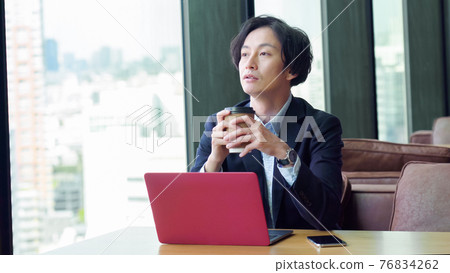 Businessman drinking coffee Businessman drinking coffee 76834262