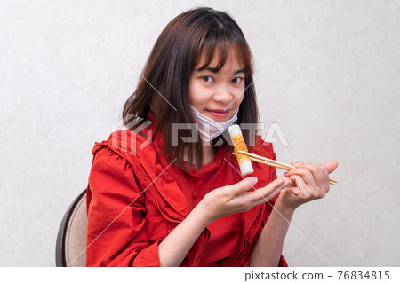 Young woman having a mask dinner Young woman having a mask dinner 76834815