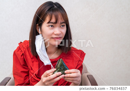Young woman having a mask dinner Young woman having a mask dinner 76834837