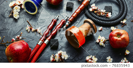 Smoking hookah or shisha with apple flavor Smoking hookah or shisha with apple flavor 76835943