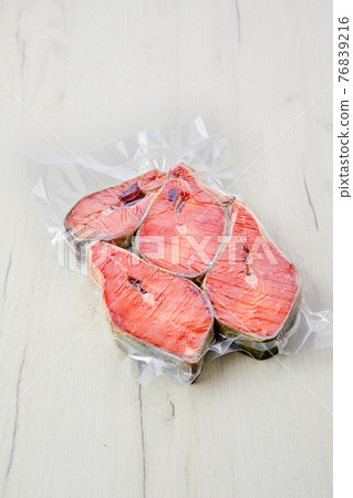 Overhead view of raw salmon steak in vacuum packaging 76839216