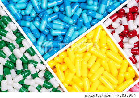 Top view colorful antibiotic capsule pills in plastic box. Antibiotic drug resistance concept. Drug of choice. Drug selection for treatment infectious disease. Pharmaceutical industry. Pharmacology. 76839994
