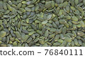 Peeled pumpkin seeds close up 76840111
