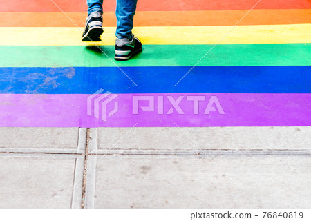 Feet Walking on Sidewalk Decorated with Rainbow Flag Feet Walking on Sidewalk Decorated with Rainbow Flag 76840819